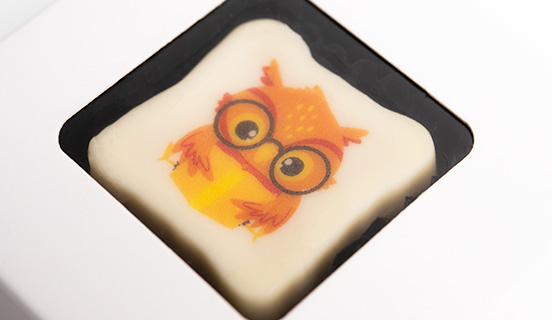 Schokoladenpraline mit Eulen-Print aus der Tüte zum Schulanfang