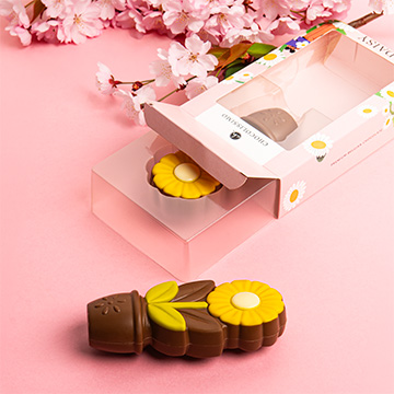 Gelbes G&auml;nsebl&uuml;mchen aus belgischer Vollmilchschokolade als Geschenk